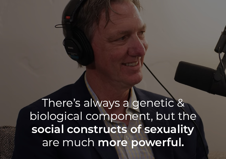 Dr. Philip Hemphill speaking into a podcast microphone with a text overlay: There's always a genetic and biological component, but the social constructs of sexuality are much more powerful.