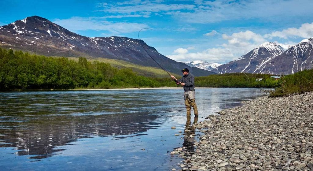 man fly fishing in Colorado stream - APN Lodge