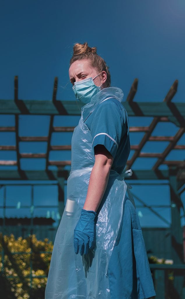 A healthcare worker dressed in full PPE outside.