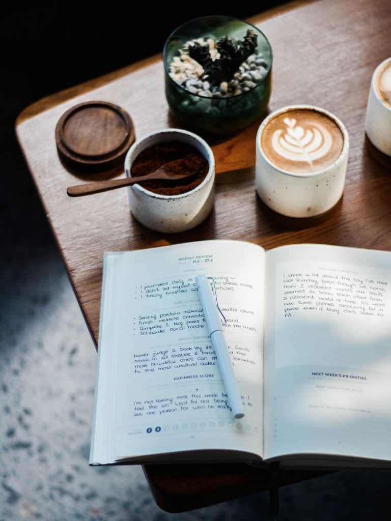 Journaling with a gratitude journal and a latte.