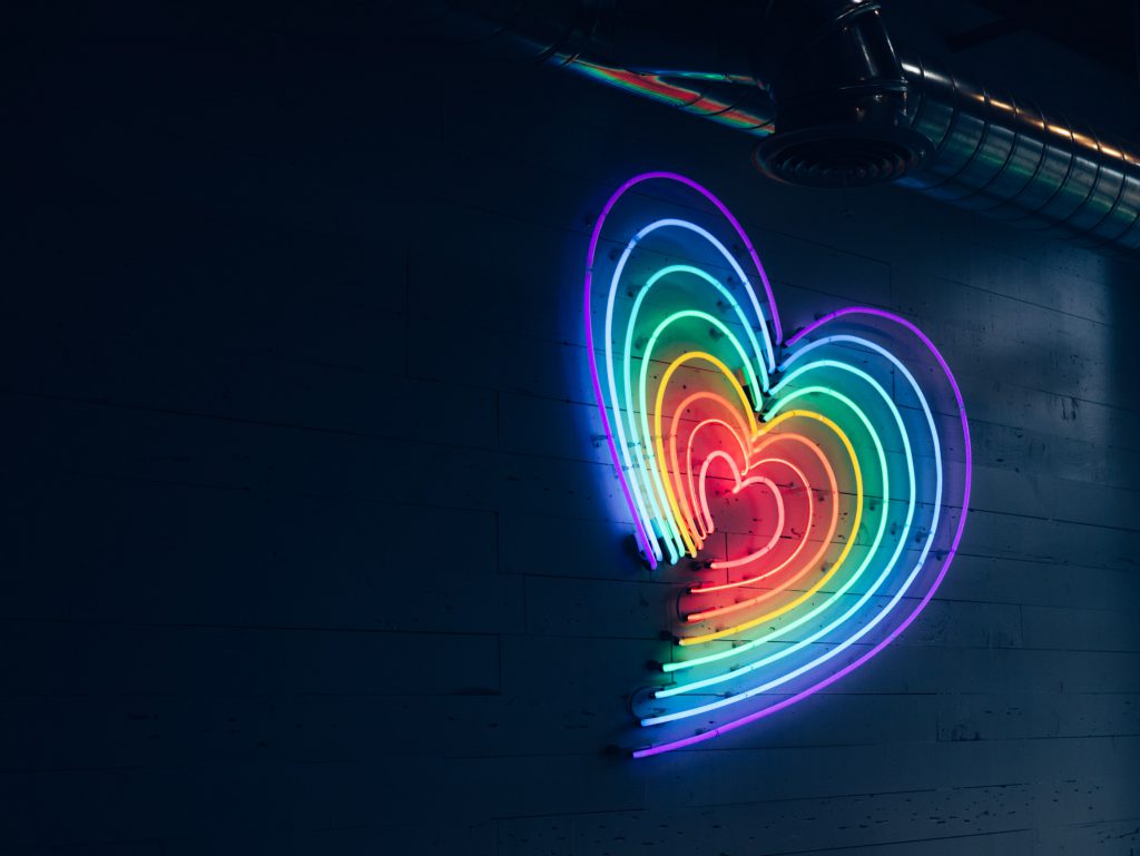 A growing rainbow neon heart.