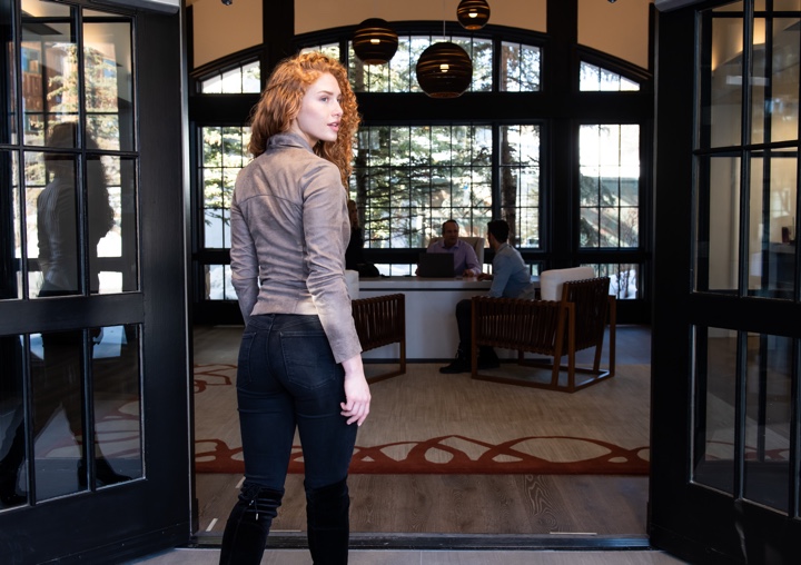 Woman walking into entryway of APN Lodge