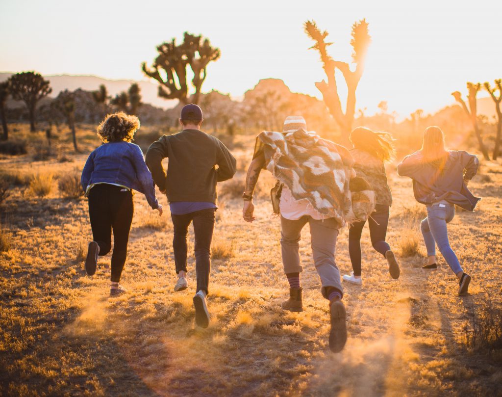 Teenagers running in the desert at Joshua Tree.