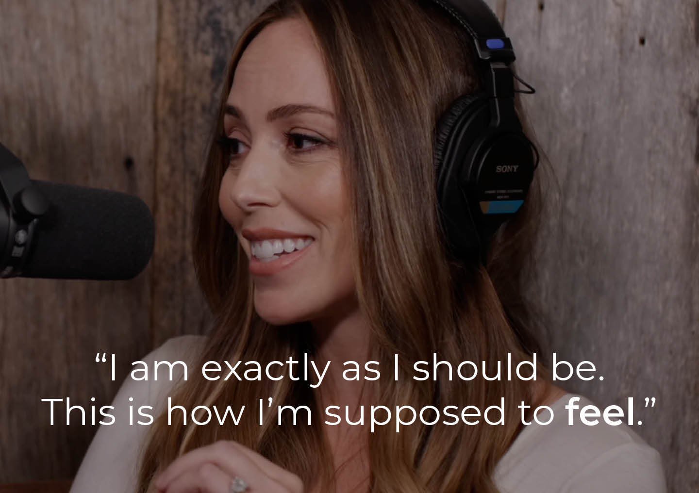 Abbey speaking into a podcast microphone with a text overlay: