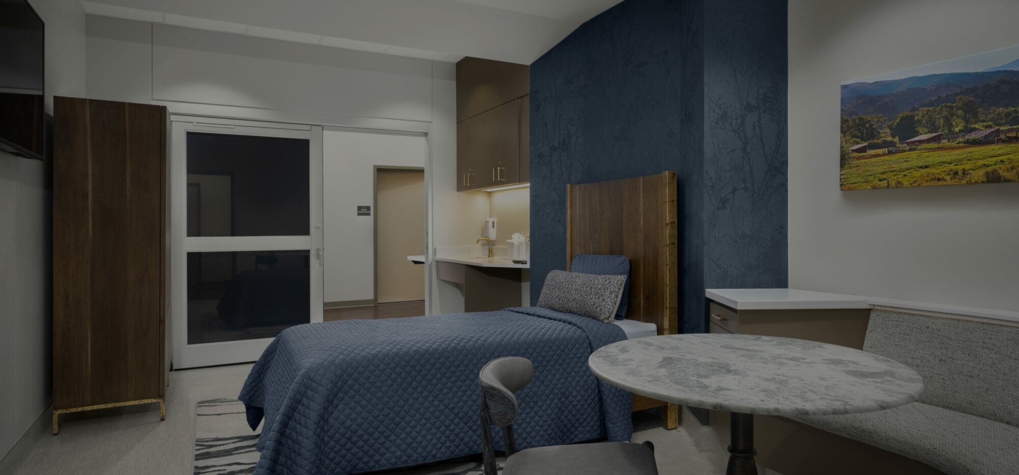 Private detox room with luxury mattress, table, and sink