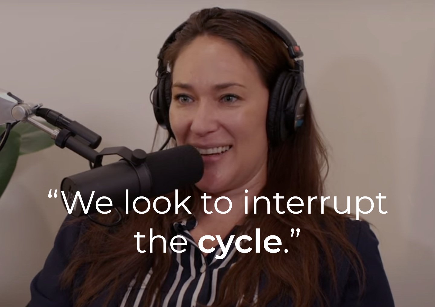 Lana Seiler speaking into a podcast microphone with a text overlay: