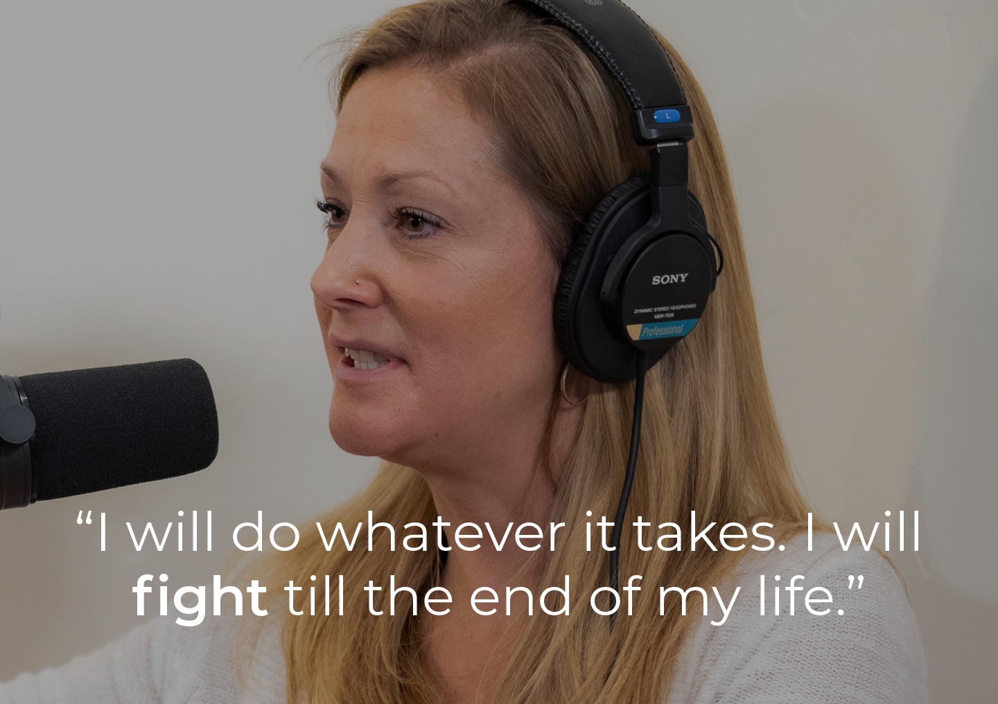 Katy speaking into a podcast microphone with a text overlay: I will do whatever it takes. I will fight till the end of my life.