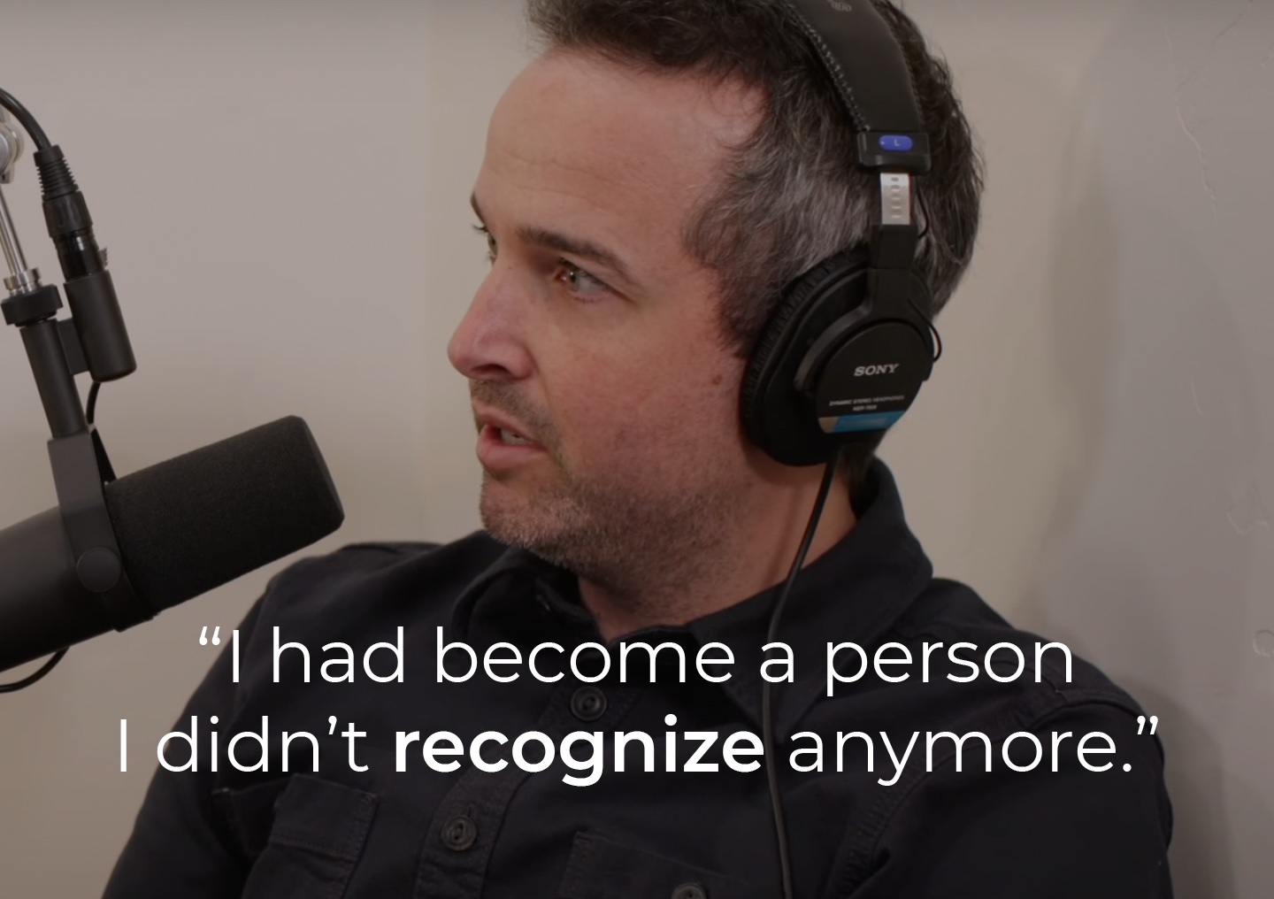 Kyle speaking into a podcast microphone with a text overlay: I had become a person I didn't recognize anymore.