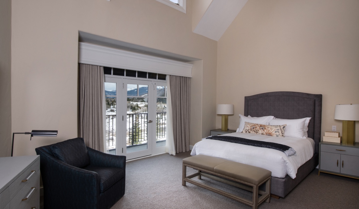 Bedroom with high ceilings mountain window view