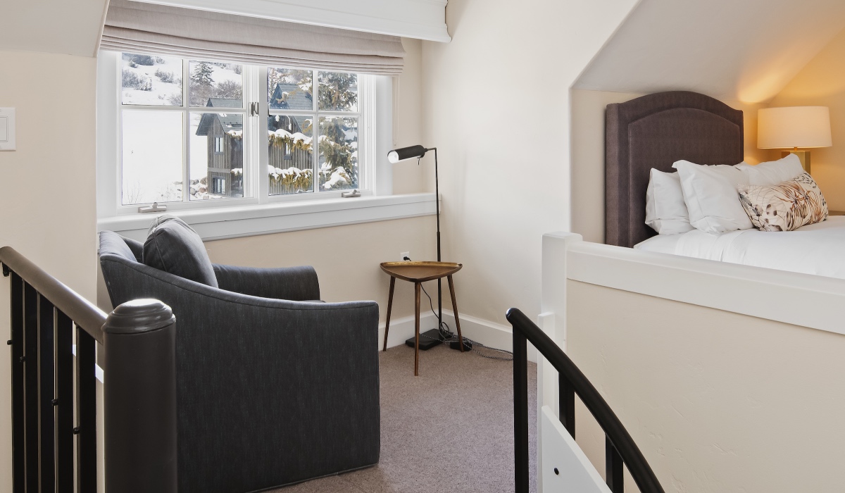 Stairway Up to Semi-Private Suite with armchair, window, and bed