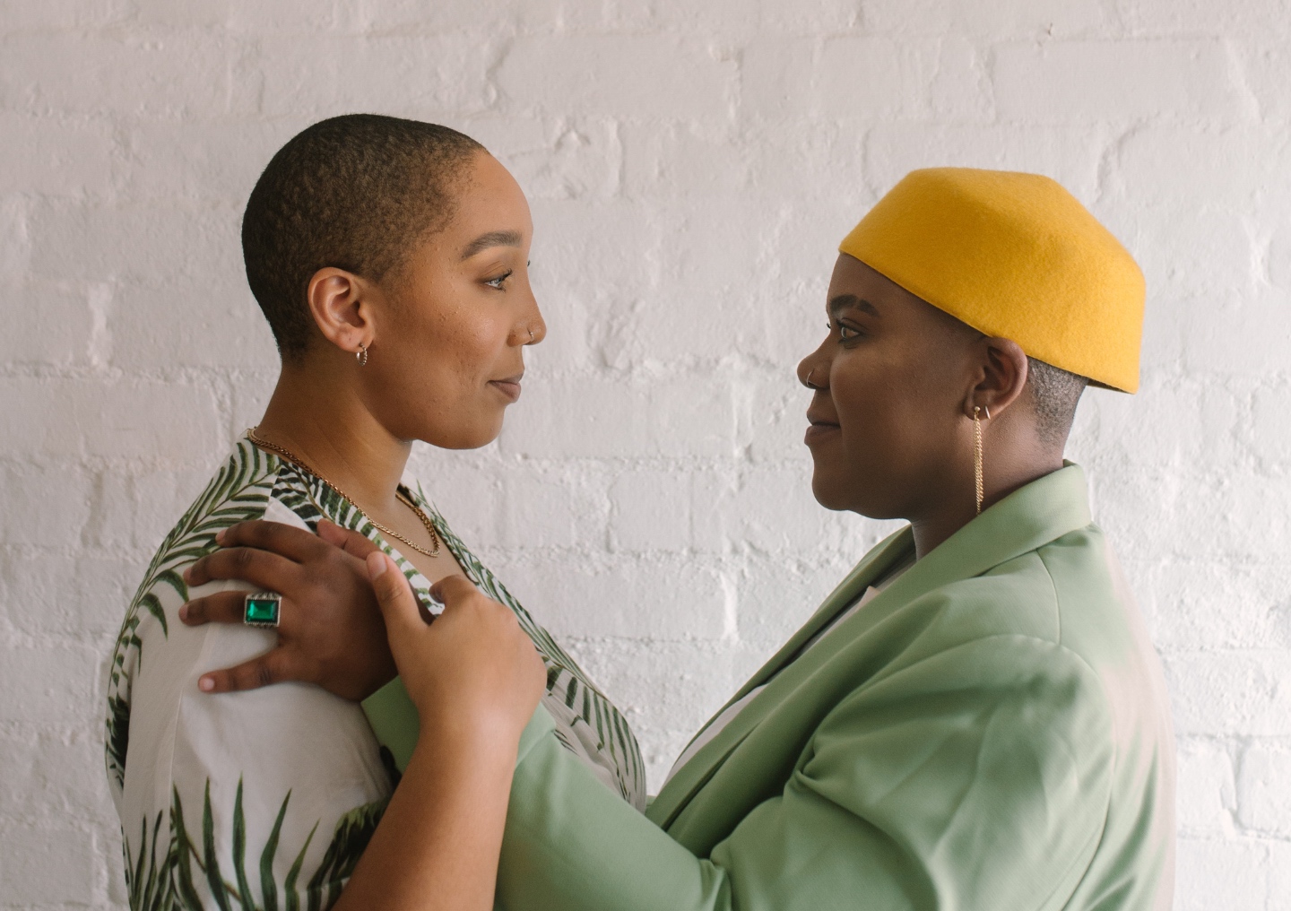 Two people making eye contact and gentle embracing.