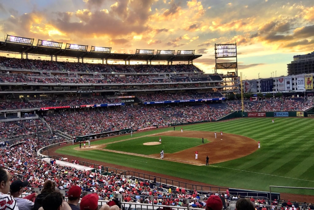 Sunset at a crowded baseball stadium.