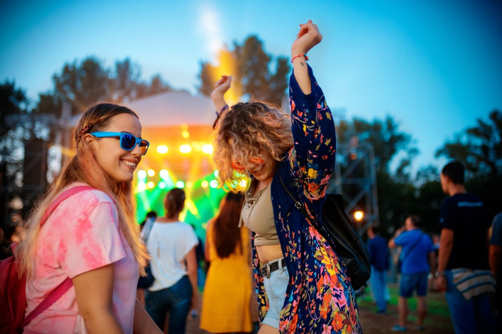 Two women enjoy a sober music festival.