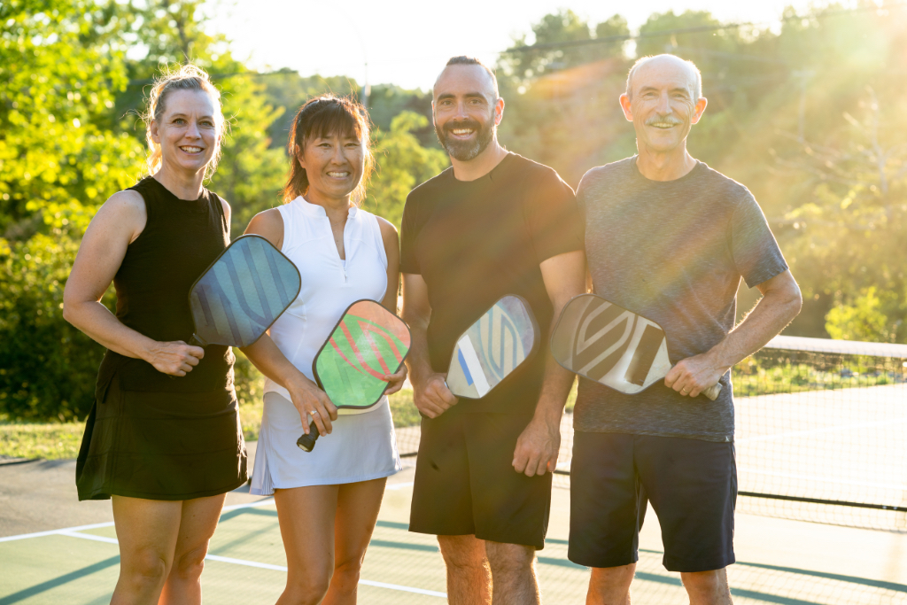 Four friends gather on the pickleball court.