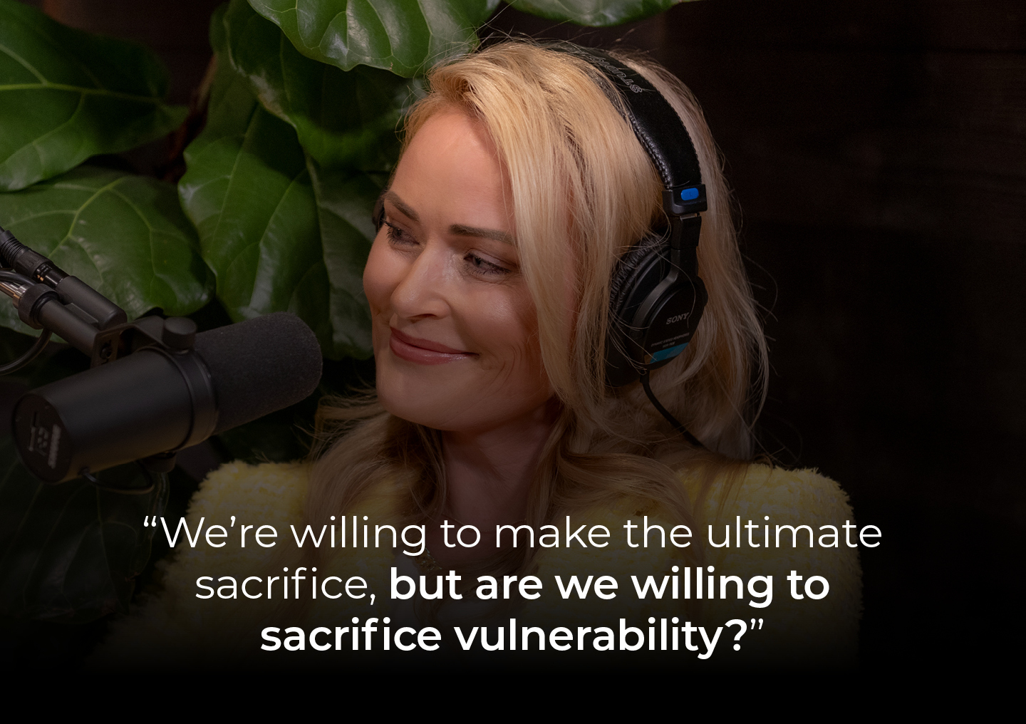 Elle speaking into a podcast microphone with a text overlay: We're willing to make the ultimate sacrifice, but are we willing to sacrifice vulnerability?
