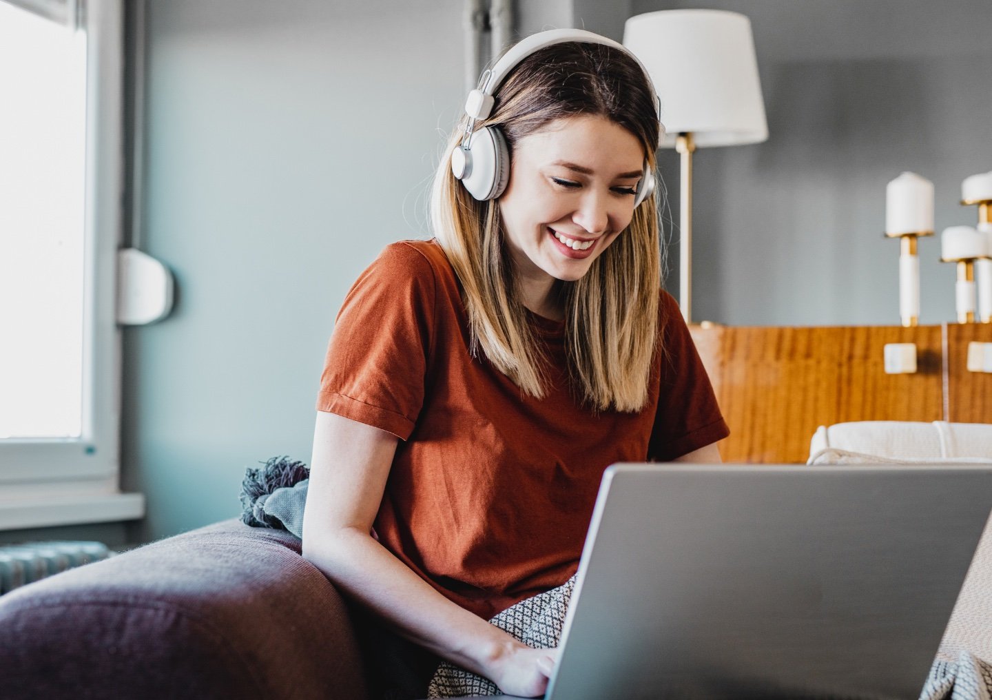 An APN client takes a virtual therapy session from the couch.