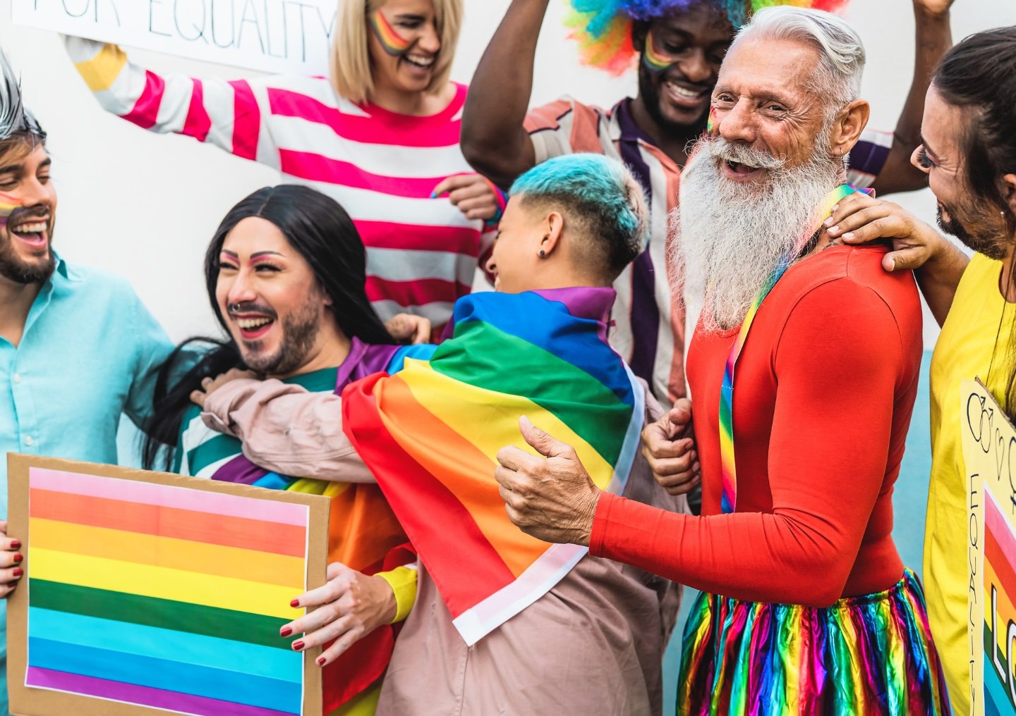 A group of people celebrate at a Pride parade.