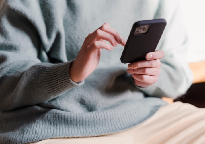 A person holds an iPhone to call for help.