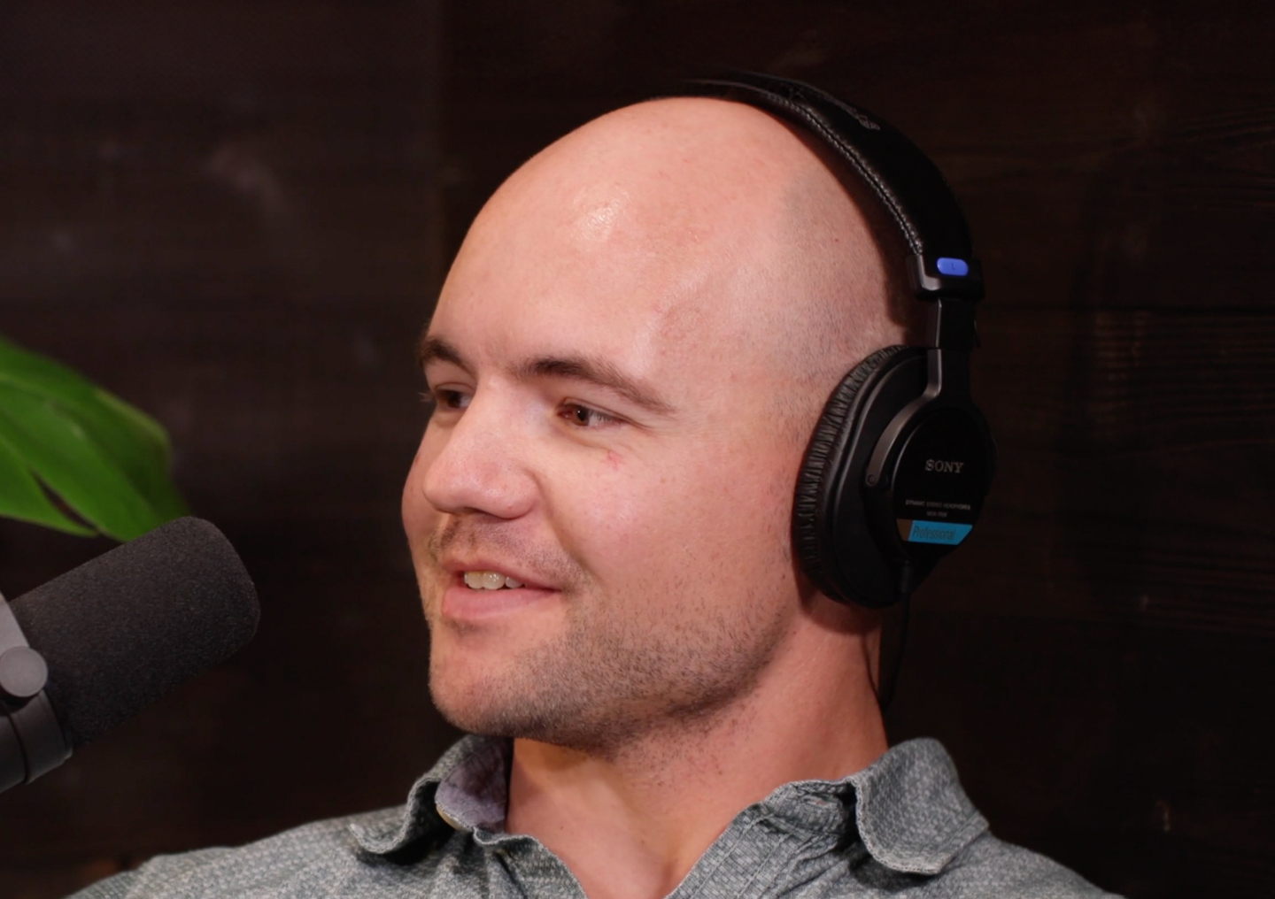 Chris Borland talks into a microphone on the Tackling Stigma podcast miniseries.