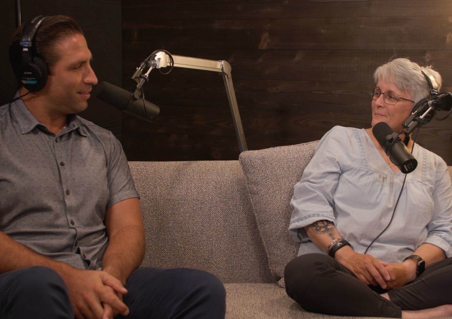 Anthony Fasano talks into a microphone with Tami Romano on the Tackling Stigma podcast miniseries.