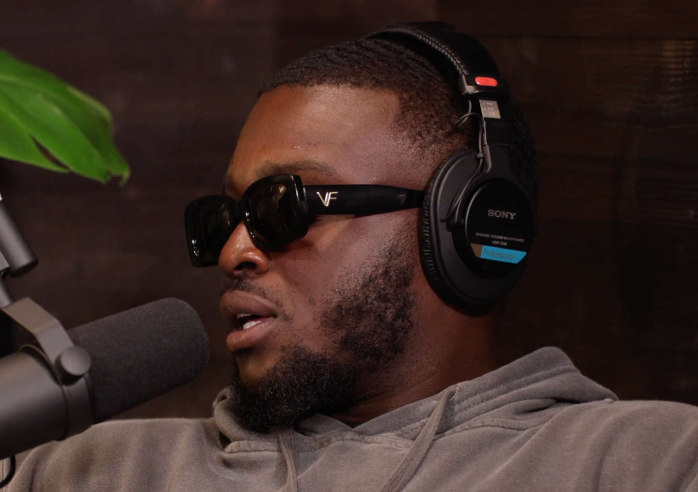 Jude Adjei-Barimah talks into a microphone on the Tackling Stigma podcast miniseries.