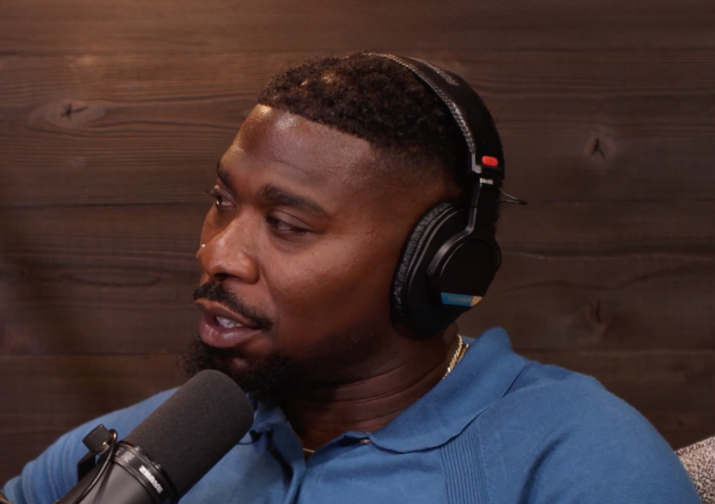 Zac Stacy talks into a microphone on the Tackling Stigma podcast miniseries.