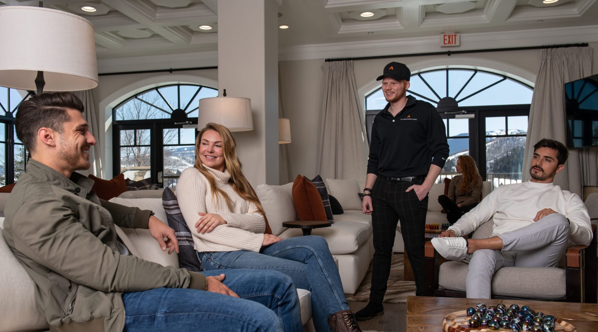 A group talking together on sofas in a bright lobby.