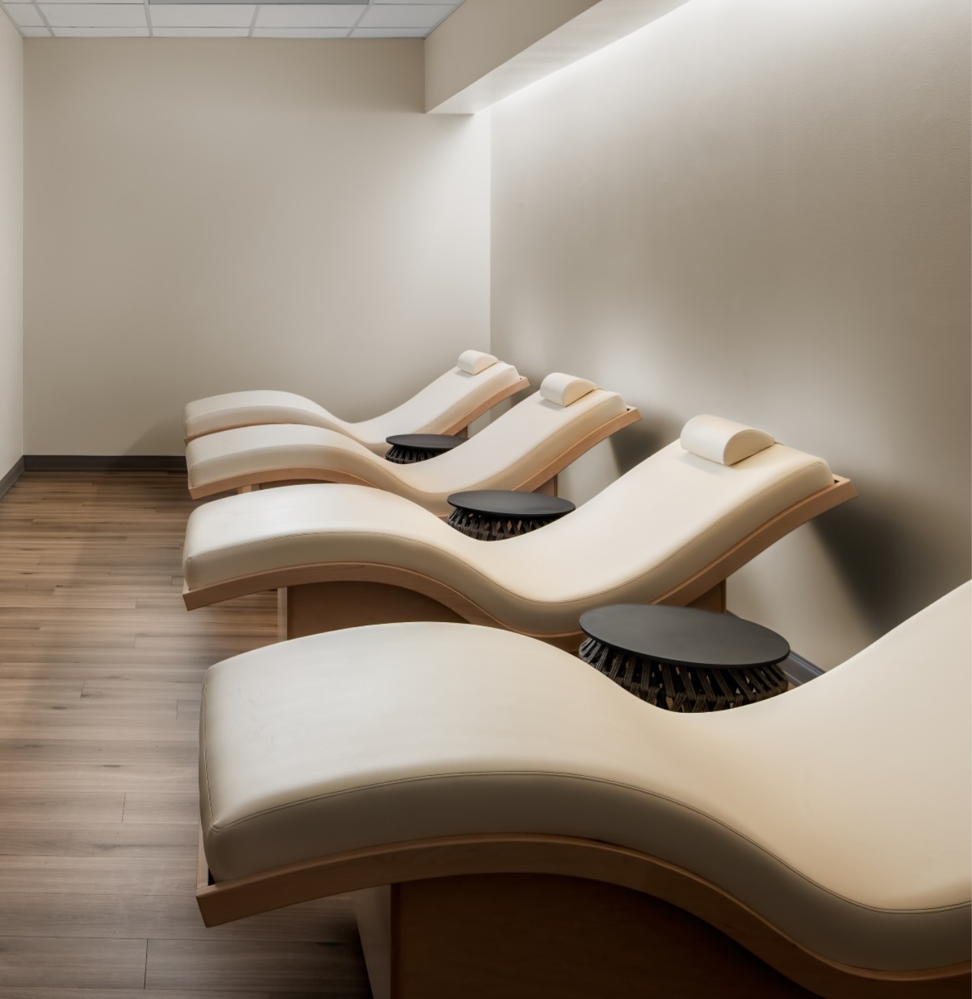 The spa at APN Dallas-Fort Worth: a dimly lit room with luxe spa recliners.