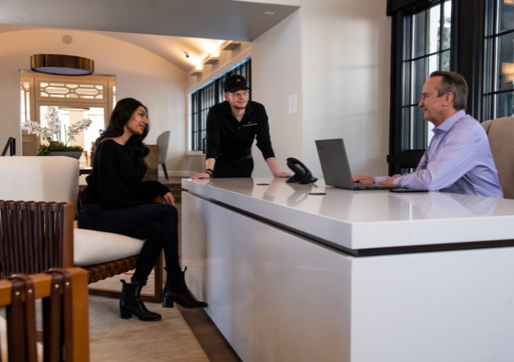 Two APN employees sit with a client during the admissions process.